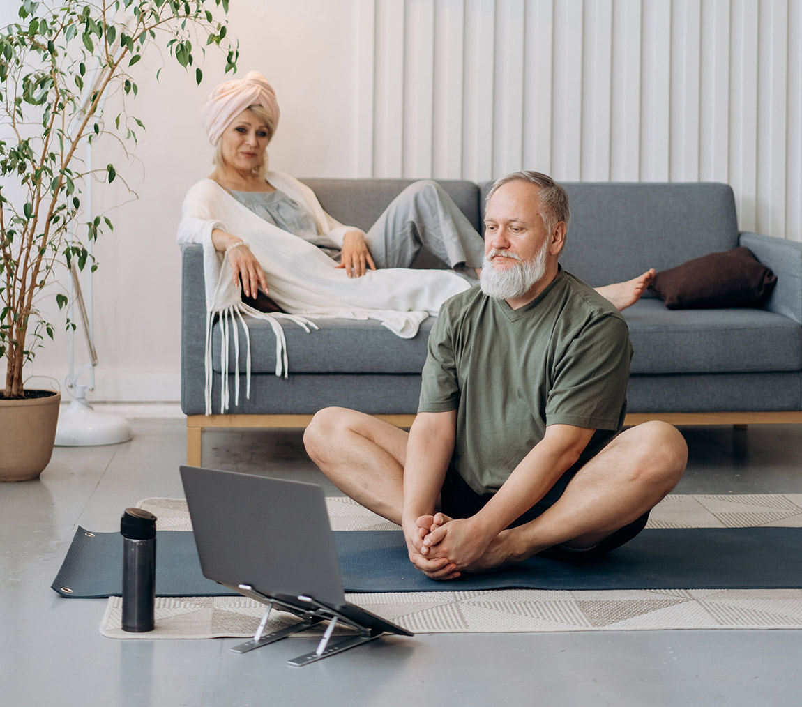 Older couple sitting in a minimal decor livingroom.