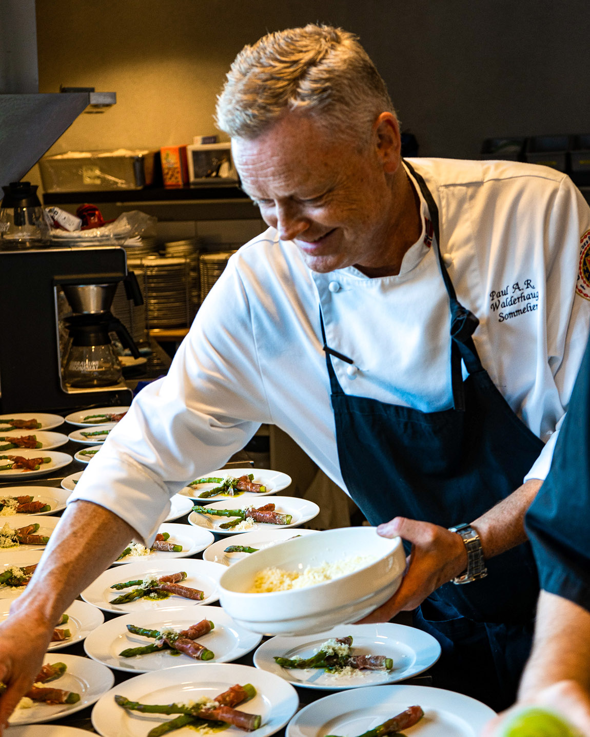 The chefs at Det Gode Selskap preparing a meal for a large catered event.